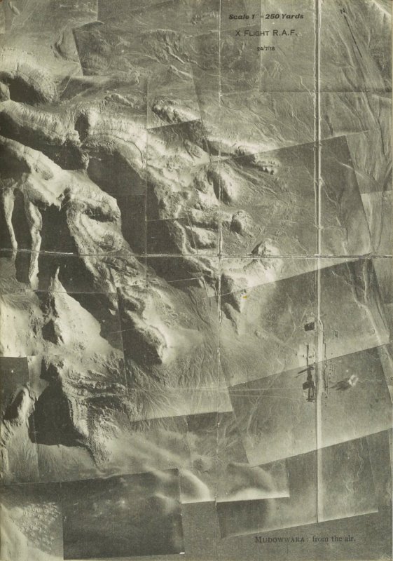 Several stitched photographs from an aeroplane showing the city of Mudowwara and the surrounding desert and mountains.